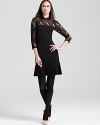 Sheer lace lends provocative edge to this DKNY dress, finished with a ruffled hemline for a darling yet dramatic look.