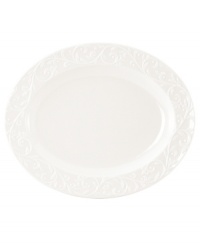 An elegant white-on-white pattern, embossed vine motif and interior glaze lend the Lenox Opal Innocence Carved oval serving platter to refined dining every day.