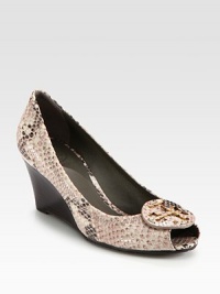 Python-print leather pump has a stacked wedge, peep toe and designer emblem. Stacked wedge, 2½ (65mm)Python-print leather upperLeather liningRubber solePadded insoleImportedOUR FIT MODEL RECOMMENDS ordering true size. 