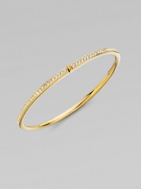 EXCLUSIVELY AT SAKS. A row of shimmering channel-set crystals within a glowing, golden hinged bangle. Crystal 18k goldplated Diameter, about 2¼ Push-lock clasp Imported