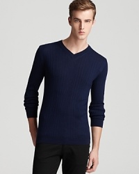 In pure wool, this V-neck sweater boasts allover ribbing and clean, classic style.