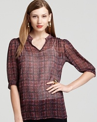 The classic dress shirt gets a modern rethink as a sheer silhouette and edgy plaid print shake up this Shiloh770 blouse.