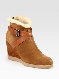 Urban-cool suede and leather essential, lined with shearling and heightened by a comfortable wedge. Suede-covered wedge, 3½ (90mm)Rubber platform, ½ (15mm)Compares to a 3 heel (75mm)Weatherproof suede and leather upper with faux shearling trimBack zip and adjustable leather strapFaux shearling liningSlip resistant rubber solePadded insoleMade in Italy