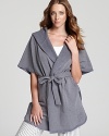 Cozy up in soft fleece with DKNY's three-quarter sleeve hooded wrap, perfect over pajamas or after a shower.