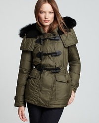 Utilitarian-style pockets and statement toggle closures lend military inspiration to a Burberry Brit down jacket, finished with a luxe fur-trimmed hood and a flattering cinched waist for the ultimate in cold-weather chic.