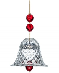 Set the tone for a beautiful holiday. The bell ornament from Baccarat illuminates the tree with faceted red beads and cut crystal on a strand of gold.