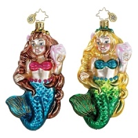 Celebrate Christmas by the seashore with this shimmering mermaid ornament, iridescent seashell in hand.