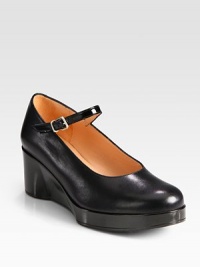 A patent leather wedge and adjustable ankle strap add a touch of sheen to this leather Mary Jane silhouette. Patent leather wedge, 2¼ (60mm)Patent leather platform, ¾ (20mm)Compares to a 1½ heel (40mm)Leather upperAdjustable patent leather strapLeather lining and solePadded insoleImported