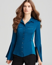 Detailed pockets and flared sleeves lend a retro feel to this Elie Tahari blouse, crafted in stretch silk.