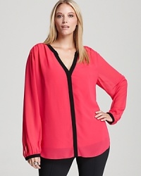 Approach color blocking with sophisticated restrain this season. A chic DKNYC Plus blouse features clean lines and contrast trim for a thoroughly modern look.