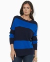 A soft knit sweater is crafted with a chic ballet neckline for feminine allure.