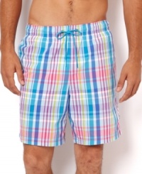 Get preppy by the pool in these stylish plaid print swim trunks by Nautica.