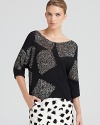 A chic, abstract intarsia print enriches this DIANE von FURSTENBERG sweater with the color blocked look of the season.