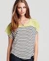 Classic black and white stripes, accented with on-trend color blocking, enliven this wispy silk Joie top.