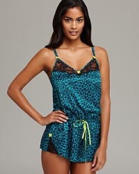 Strike a wildly evocative look between the sheets in Betsey Johnson's animal-print romper, trimmed with lace and bright bows.