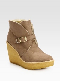 Casual faux suede essential with an adjustable buckle strap, mock shearling lining and elevated rubber wedge. Rubber heel, 3¾ (95mm)Rubber platform, 1¼ (30mm)Compares to a 2½ heel (65mm)Faux suede upperAdjustable buckle strapFaux shearling liningRubber solePadded insoleImported