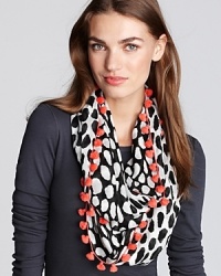 Bright pom poms bring a fun finish to DIANE von FURSTENBERG's vacation-perfect infinity scarf, boasting double-sided prints.