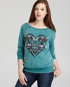 A patterned heart graphic emboldens this CHASER pullover with eclectic flair.