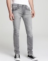 These unique jeans mesh with your authentic style, faded and distressed throughout for a masculine edge. From True Religion.