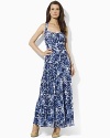 A breezy maxi dress is rendered in a bold print with a chic crossed back for a modern look.