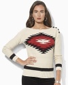 A soft knit sweater is crafted with a Southwestern-inspired pattern at the front and rustic buttons at the shoulder.