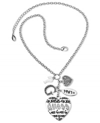 Let your love show with this charming bracelet from GUESS. Features dangling charms in heart, G logo, year logo, and question mark designs. Embellished with jet epoxy and crystal accents. Crafted in silver tone mixed metal. Approximate length; 18 inches + 2-inch extender. Approximate drop: 3 inches.