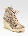 Classic ankle-grazing silhouette modernized by a snake-print faux leather upper, lace-up front and an espadrille wedge. Braided hemp wedge, 4 (100mm)Braided hemp platform, 1 (25mm)Compares to a 3 heel (75mm)Snake-print faux leather and burlap upperFaux leather liningRubber solePadded insoleMade in SpainOUR FIT MODEL RECOMMENDS ordering true whole size; ½ sizes should order the next whole size up. 