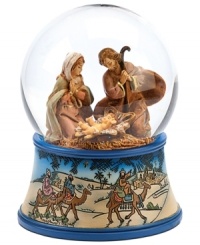 A delightful keepsake for family and friends, this religious snow globe depicts Mary and Joseph at the birth of baby Jesus. The blue-trimmed etched base features the three wise men atop camels, journeying to deliver gifts to the newborn.