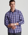 Michael Kors' check printed sport shirt boasts a classic fit and vibrant color palette.