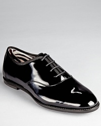 A tap dance inspired silhouette from Salvatore Ferragamo looks smart in glossy patent leather. A zebra print lining adds a playful touch.