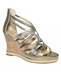 Tahari takes the wedge to a new level of elegance with the Isla design. Metal-colored leather straps curve across the foot and zip up at the back while a slender cork wedge is grounded by espadrille trim.