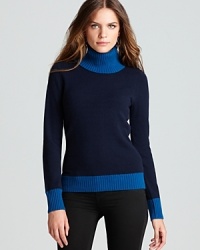 A modern classic, crisp color blocking takes a cashmere Jones New York Collection turtleneck from staple to statement.