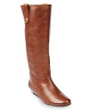 This riding boot-influenced STEVEN BY STEVE MADDEN style features tab details set on downtown-style wedges.