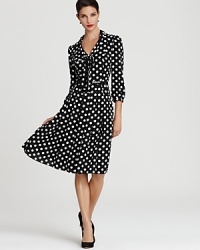 Playful polka dots lend a cheerful look to a timeless Anne Klein swing dress, exuding a faint retro feel.