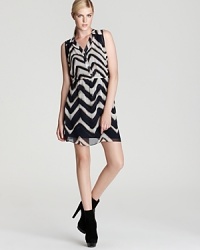 Aqua's graphic zig zag print dress is modern in its design and versatility; this seasonless favorite layers effortlessly for year-round wear.