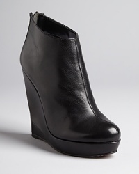 Sculpted, architectural wedge heels define these streamlined Dolce Vita booties.