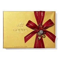 A classic assortment of Belgian chocolates from Godiva comes in a beautiful gold box tied with big red bow and holiday pick. Each ballotin includes Godiva signature favorite ganaches, pralines, caramels, fruits and nuts in milk, dark and white chocolate.