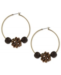 Take a walk in these nature-inspired hoops from Kenneth Cole New York. The design features brown wood and bronze tone faceted fireball beads. Crafted in gold tone mixed metal. Approximate drop: 2 inches.