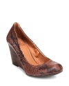 High-fashion snake-textured leather meets low-key comfortable wedges in this Lucky Brand design.