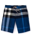 In an allover check print, these iconic swim trunks from Burberry take classic style to the seaside.