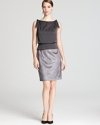 In soft grey hues, Aidan Mattox's two-tone dress pairs a silky bodice with a shimmering skirt reminiscent of crushed velvet.