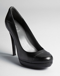 Calvin Klein reinvents a classic black platform pump with subtle stitched details.