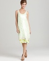 A neon crochet DIANE von FURSTENBERG dress features a clear sequin overlay for illuminating glamour while a floral-print hem lends feminine flair. Mastering party perfection with true sophistication, this silhouette stands out amongst a sea of LBDs.