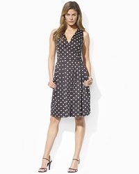 Classic polka dots accent a feminine cotton sundress, designed with a faux-wrap bodice and a full skirt for vintage-inspired elegance.