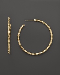 With a unique, woven-like texture, Lana Jewelry's glimmering Decades hoops are crafted in 14K yellow gold.