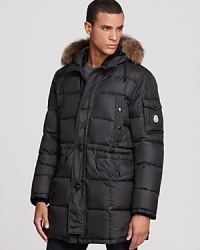 Moncler offers a commanding winter coat that deftly balances form and function with unexpected contrasts and modern craftsmanship. Take the glossy hood, for instance, which sharply offsets the matte shell but is lined with fur for a touch of luxury. Insulated with down for major warmth, and constructed for ease of movement in a trim silhouette, this coat cushions the blow of winter and provides a handsome, top-notch look anywhere you go.