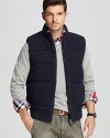 Cable knit with a stand collar and a full zip front, this sweater vest makes cooler weather easy to dress in.