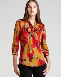 Vibrant blossoms freshen a classic AK Anne Klein blouse, finished with a decadent bow collar for a decidedly romantic style.