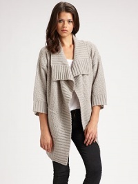 Comfy, textured design with a cropped back hem, shawl collar and bow-tie stitching. Shawl collar Open front Three-quarter sleeves Cropped back hem 85% acrylic/15% nylon Hand wash Imported