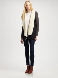 Modern take on the classic coat, this suede like design is styled with contrasting knit sleeves and plush faux shearling trim. Faux shearling shawl collarLong knit sleevesAdjustable back cordFaux shearling liningBody: PolyesterTrim: 50% acrylic/30% wool/20% nylonHand washImportedModel shown is 5'10 (177cm) wearing US size Small.